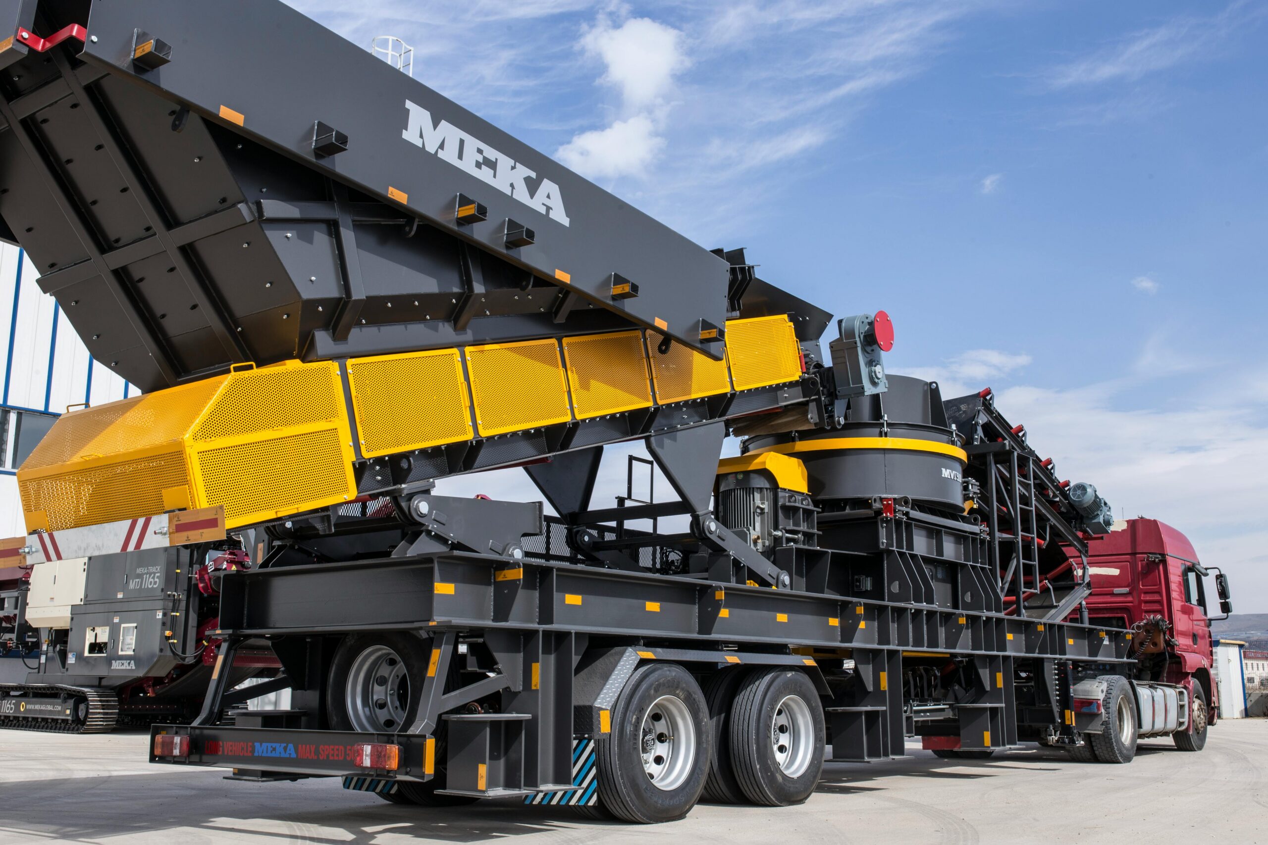 Heavy industrial equipment being transported on specialized trailer during plant relocation project