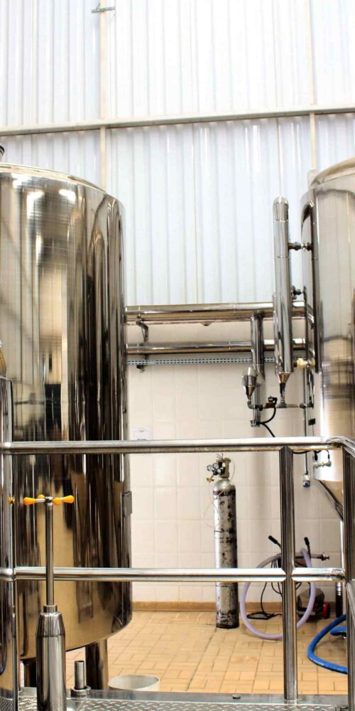 Stainless steel process vessels with sanitary piping in a food and beverage manufacturing facility