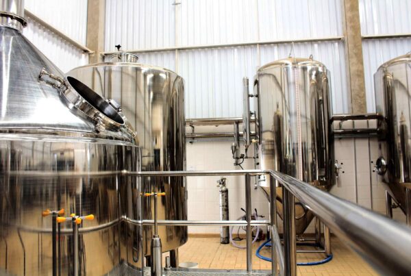 Stainless steel process vessels with sanitary piping in a food and beverage manufacturing facility