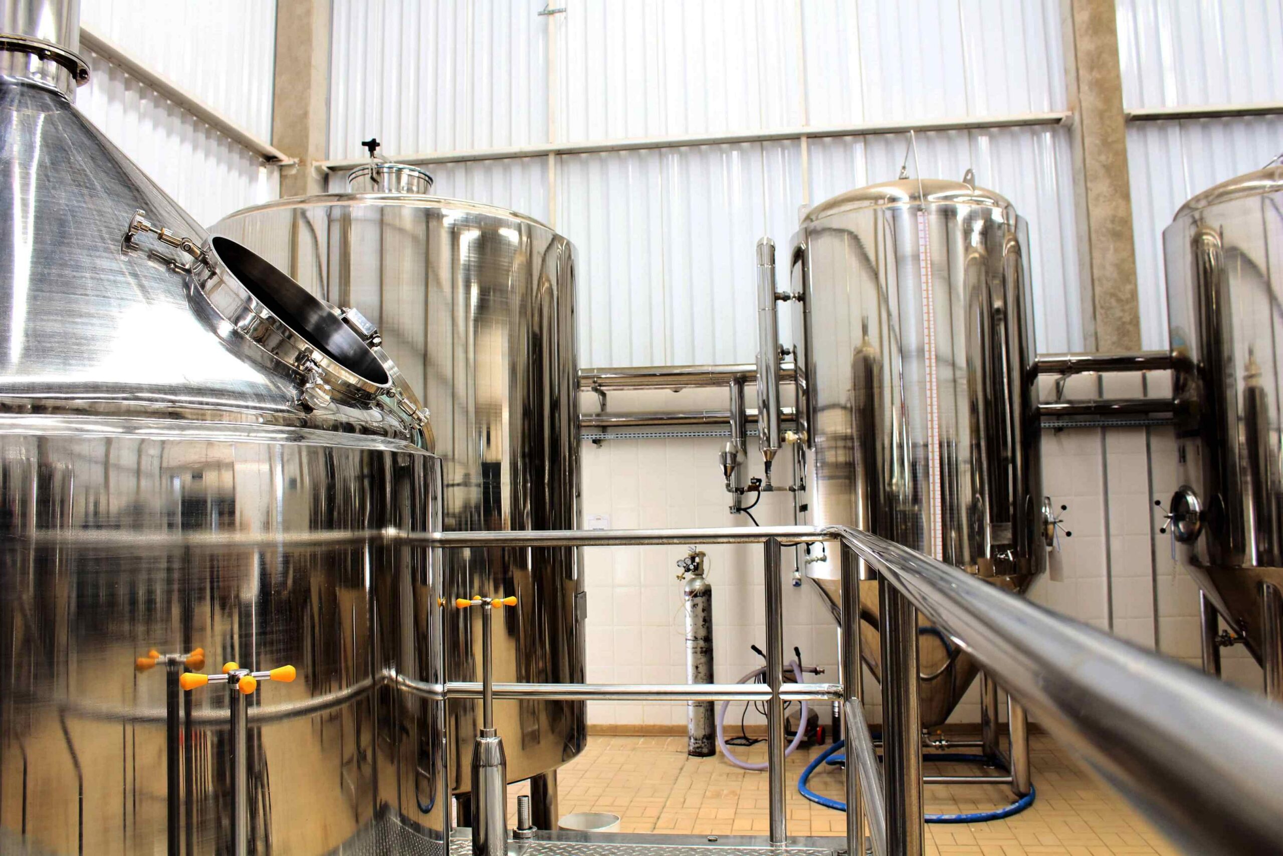 Stainless steel process vessels with sanitary piping in a food and beverage manufacturing facility